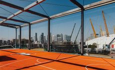 Canary Wharf and the 02 seen from the rooftop basketball court at Design District, London 