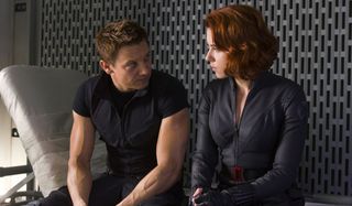 Jeremy Renner and Scarlett Johansson sitting on a cot, talking, in The Avengers.