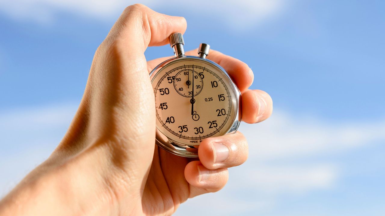 A hand with a stopwatch.