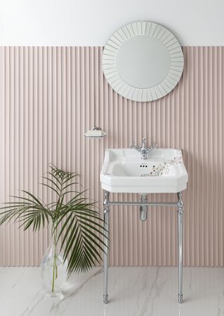 A small bathroom with a wall painted pink