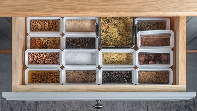 Plastic containers of of spices in drawer