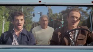 From left to right: Michael Urie sitting in the passenger seat singing, Harrison Ford sitting in the back looking confused and Jason Segel driving and singing.