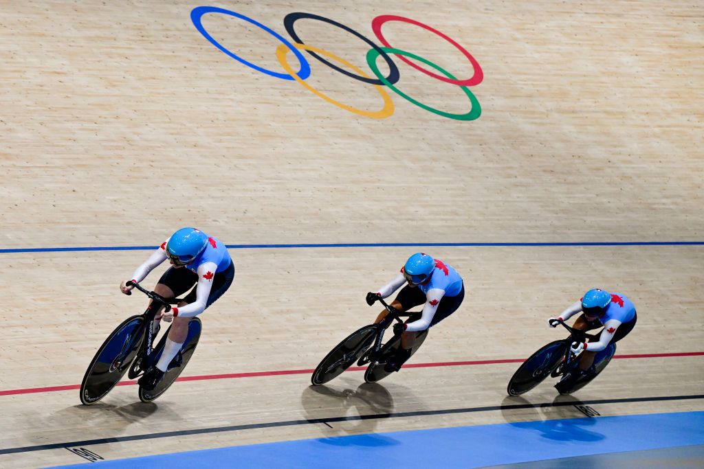 Canada&#039;s Sarah Orban, Canada&#039;s Kelsey Mitchell and Canada&#039;s Lauriane Genest compete in the women&#039;s track cycling team sprint first round of the Paris 2024 Olympic Games at the Saint-Quentin-en-Yvelines National Velodrome in Montigny-le-Bretonneux, south-west of Paris, on August 5, 2024. (Photo by John MACDOUGALL / AFP)