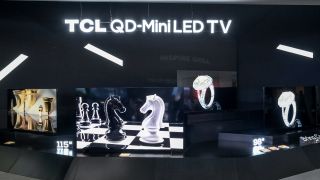 TCL X955 in two sizes on display on black stand 
