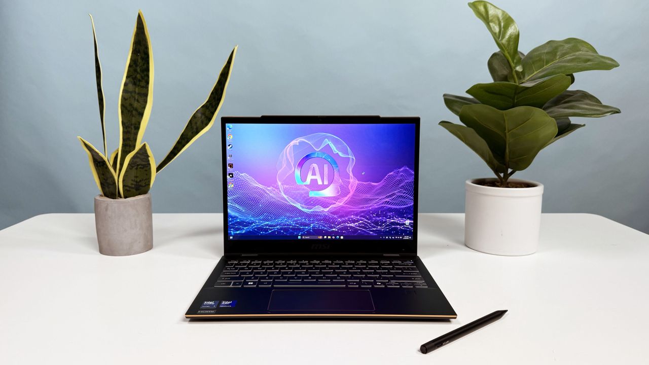 MSI Summit 13 AI+ Evo (A2VM) 2-in-1 laptop open in clamshell mode on a white table with a stylus resting in front of it and two plants behind it
