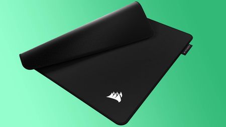A Corsair MM Pro mouse pad on a green background.