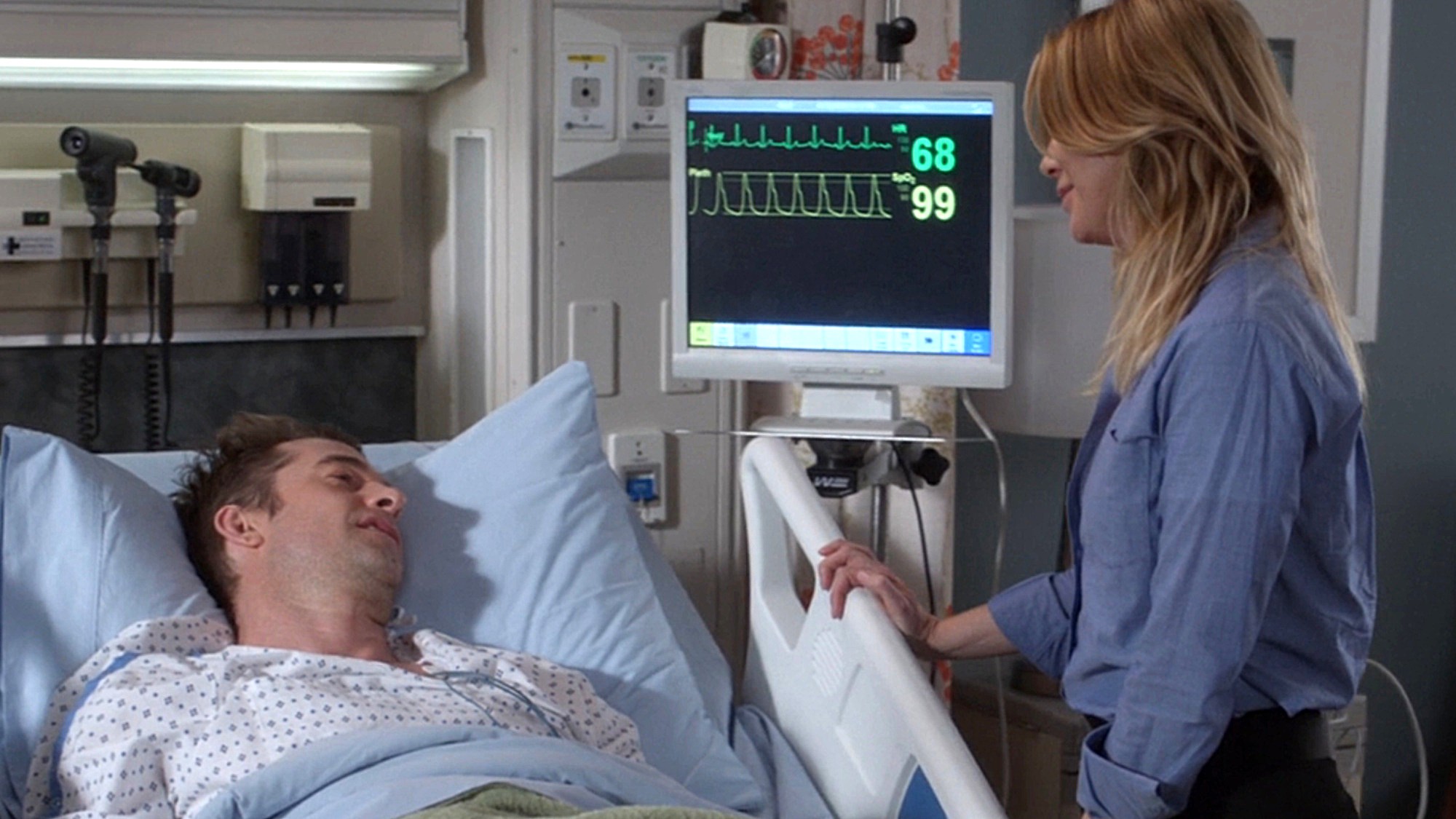 Meredith Grey (Ellen Pompeo) stands by Nick Marsh's (Scott Speedman) bedside the first time the characters met on Grey's Anatomy Season 14.