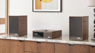 Ruark R610 and speakers on a marble shelf in a minimalist room