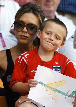 Victoria Beckham and son Brooklyn at a football match