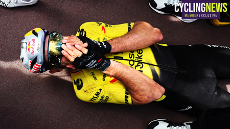 Wout van Aert lies on the ground, holding his face in disbelief after winning Paris-Roubaix 2026