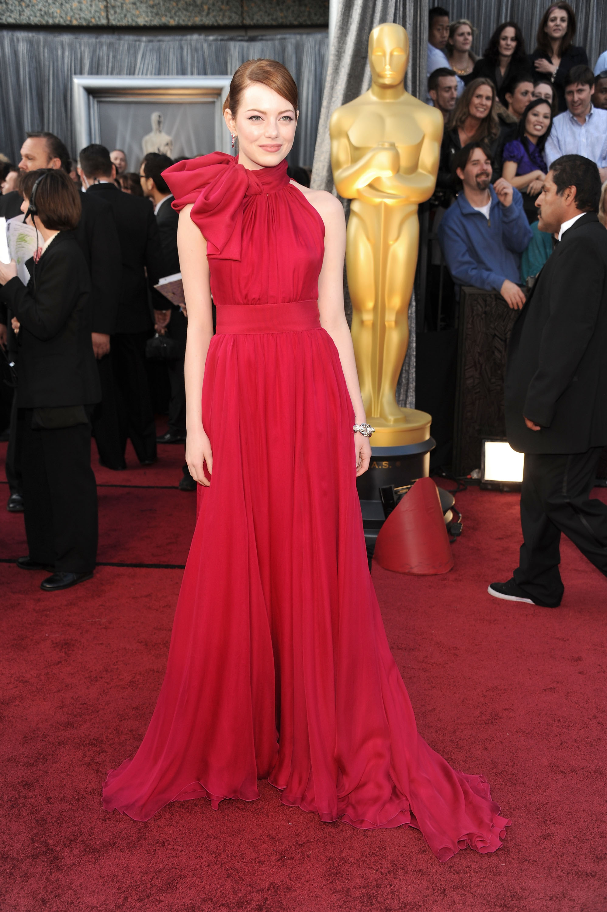 Emma Stone attends the Oscars wearing a red dress