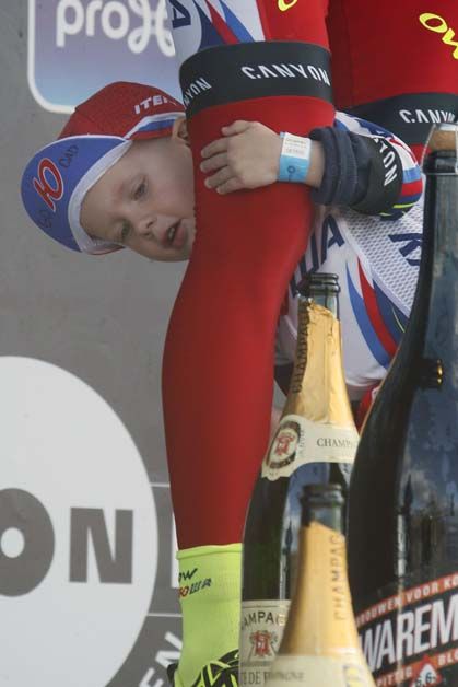 Alexander Kristoff's son clings to his leg on the podium of the Tour of Flanders