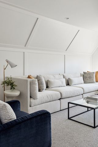 White living room with white velvet sofa