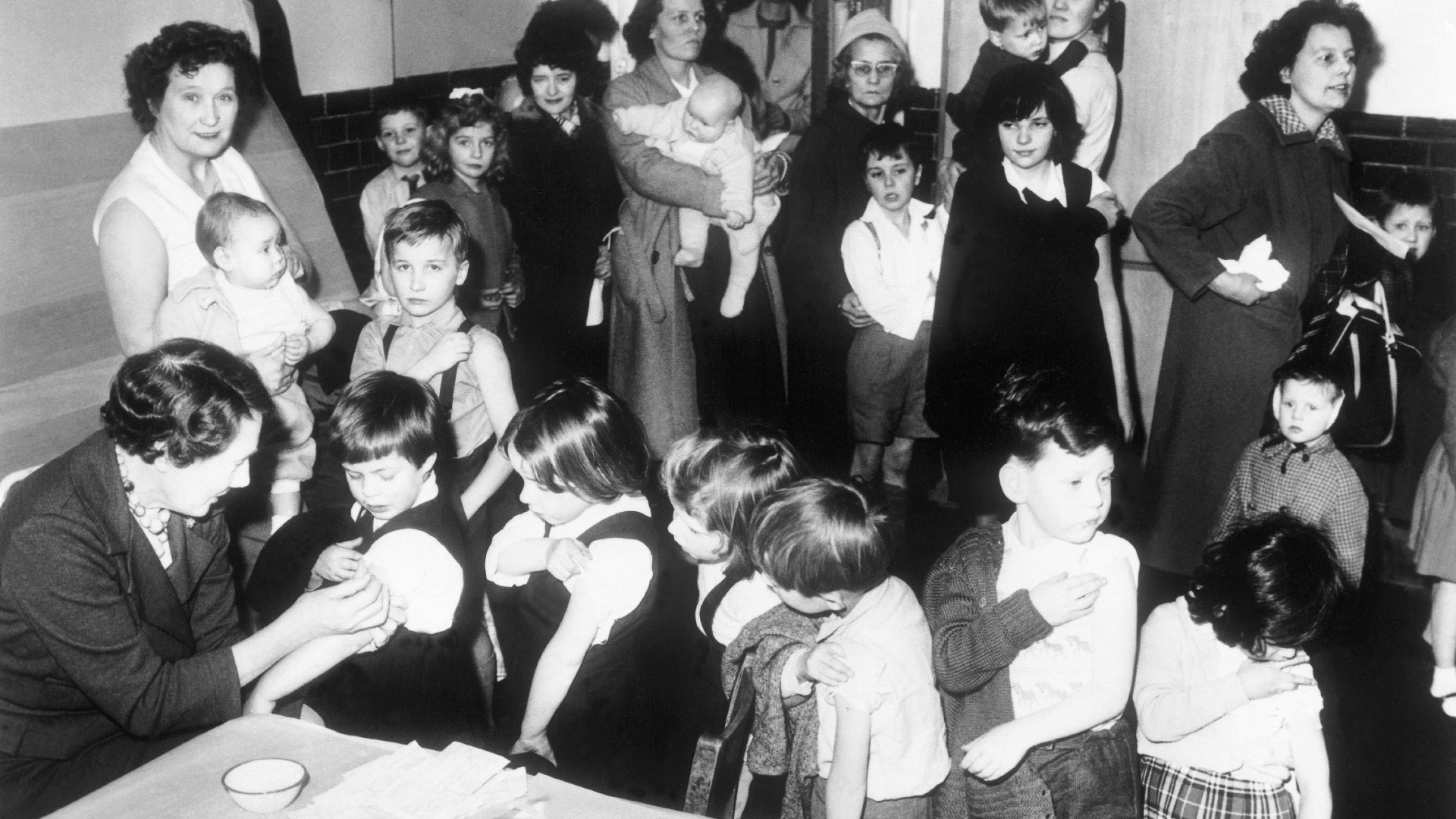 Children being vaccinated against smallpox at a school in England in 1962