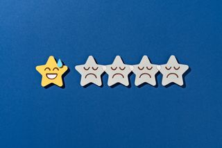 Paper Craft of Low Star Rating With Only One Embarrassing Star Left for Dissatisfaction Bad Review, on Blue Background Front View.