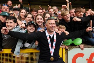 Steven Schumacher the manager / head coach of Plymouth Argyle with Plymouth Argyle fans as they celebrate being crowned champions of EFL Sky Bet League One and being promoted to the EFL Sky Bet Championship during the Sky Bet League One between Port Vale and Plymouth Argyle at Vale Park on May 7, 2023 in Burslem, United Kingdom. (Photo by James Williamson - AMA/Getty Images)