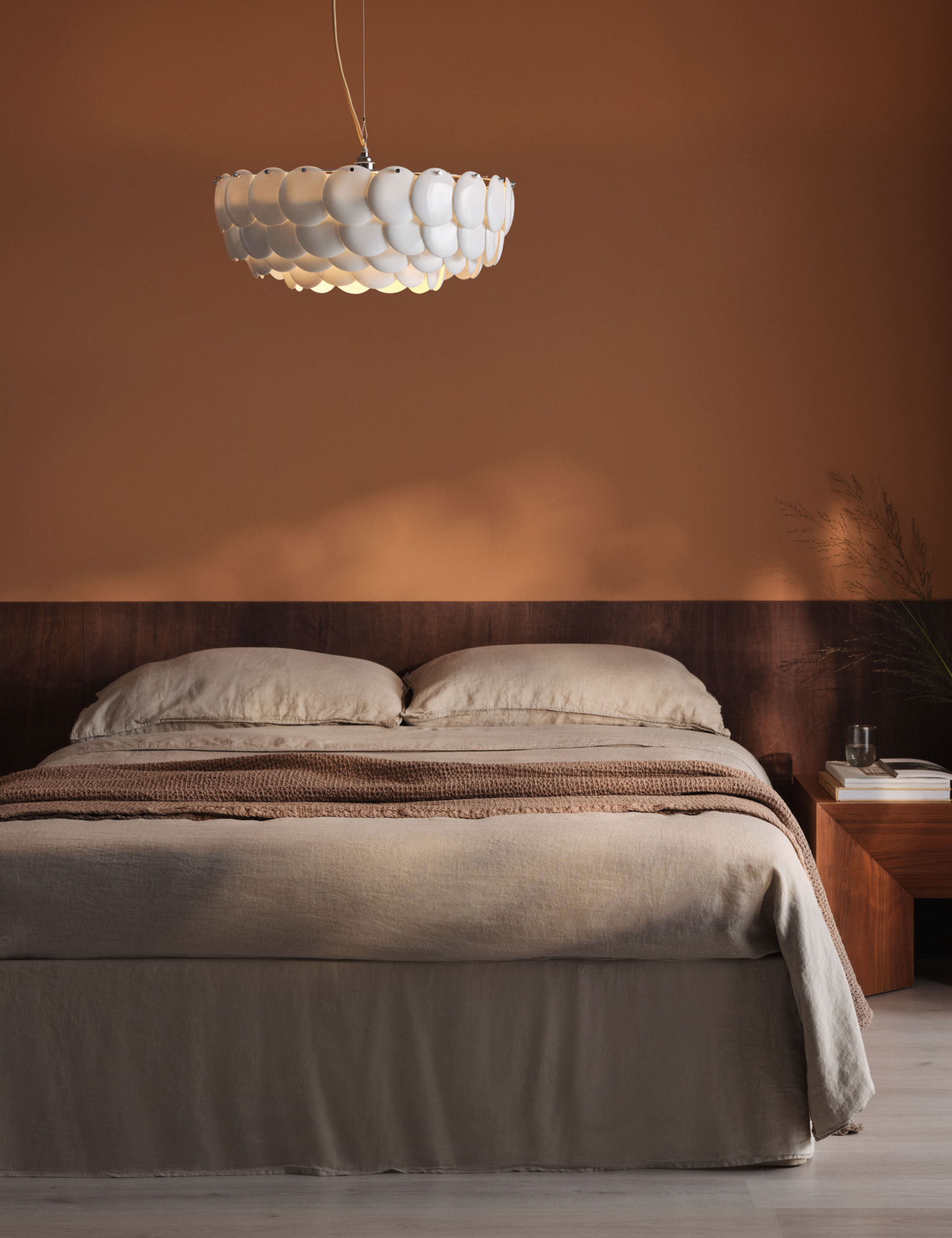 Minimalist floating bed frame pictured in a neutral bedroom