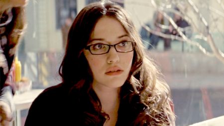Kat Dennings, wearing a dark red top and glasses in Thor (2011).