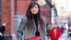 katie holmes in a grey coat and red bag