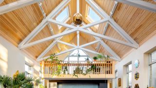 vaulted ceiling with white beams and rooflights and mezzanine level