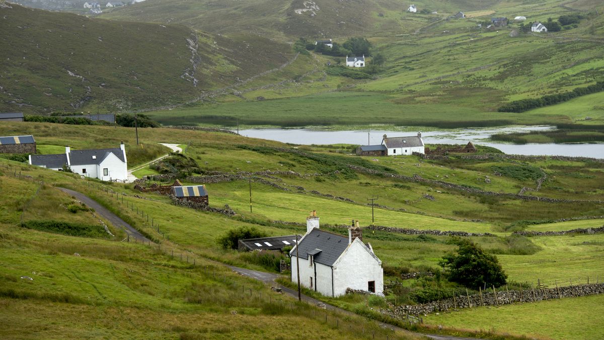 Rural mountain landscape with a few white cottages distant from one another