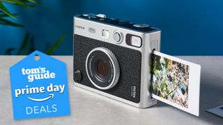 A Fujifilm Instax mini Evo sitting on a table, with a Prime Day deal badge overlayed on top of the photo