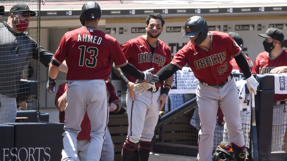 Nick Ahmed of the Arizona Diamondbacks celebrates with teammates after scoring against the San Diego Padres July 27, 2020.