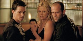 The Italian Job Mark Wahlberg, Charlize Theron, and Jason Statham look down on someone on a restaura