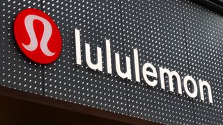 The corporate logo for Lululemon hangs on a wall at their store in Brookfield Place in New York City