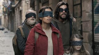 A family wander through streets in blindfolds in Bird Box Barcelona