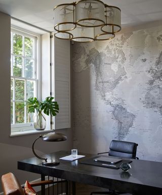 Home office with grey world map mural