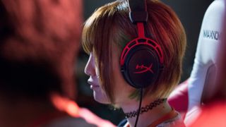 A woman wearing a pair of gaming headphones