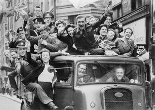 A truck of revellers passing through the Strand, London. 