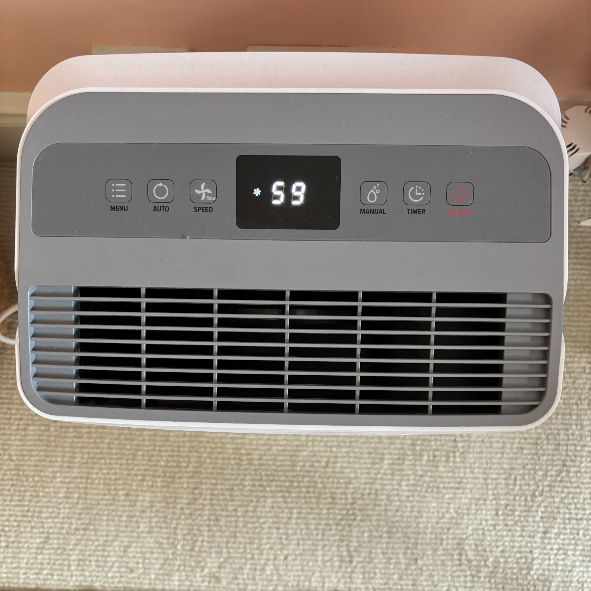dryzone dehumidifier and air purifier display panel in a bedroom