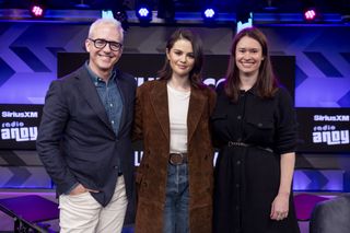 Selena Gomez posing with hosts Jess and Julia in a brown suede double-breasted overcoat from Madewell's second collaboration with Alexa Chung.