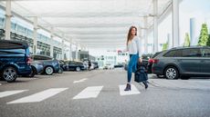 Woman walking to airport after parking car
