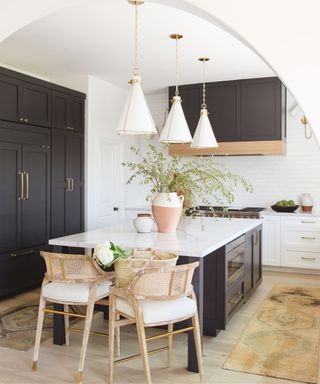 Black cabinets, white countertop, wooden chairs