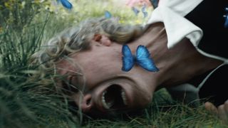 Haymitch being attacked by blue butterflies in The Hunger Games: Sunrise on the Reaping