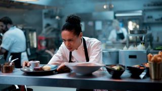Carly (Vinette Robinson) checking a meal at the pass in the Point North kitchen in Boiling Point episode 2