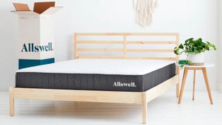 The Allswell Hybrid Mattress photographed on a light wooden bedframe in a white bedroom