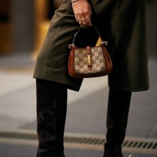 woman holding a gucci bag