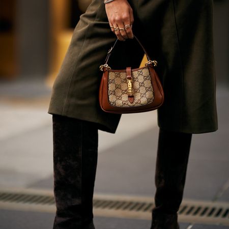 woman holding a gucci bag