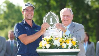 Jack Nicklaus presents the trophy to Viktor Hovland of Norway after winning in a playoff during the final round of the Memorial Tournament