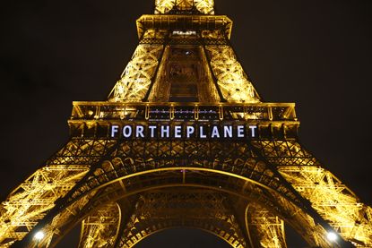 The Eiffel Tower is lit up for the climate conference in Paris.