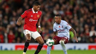 Marcus Rashford of Manchester United controls the ball whilst under pressure from Ashley Young of Aston Villa 