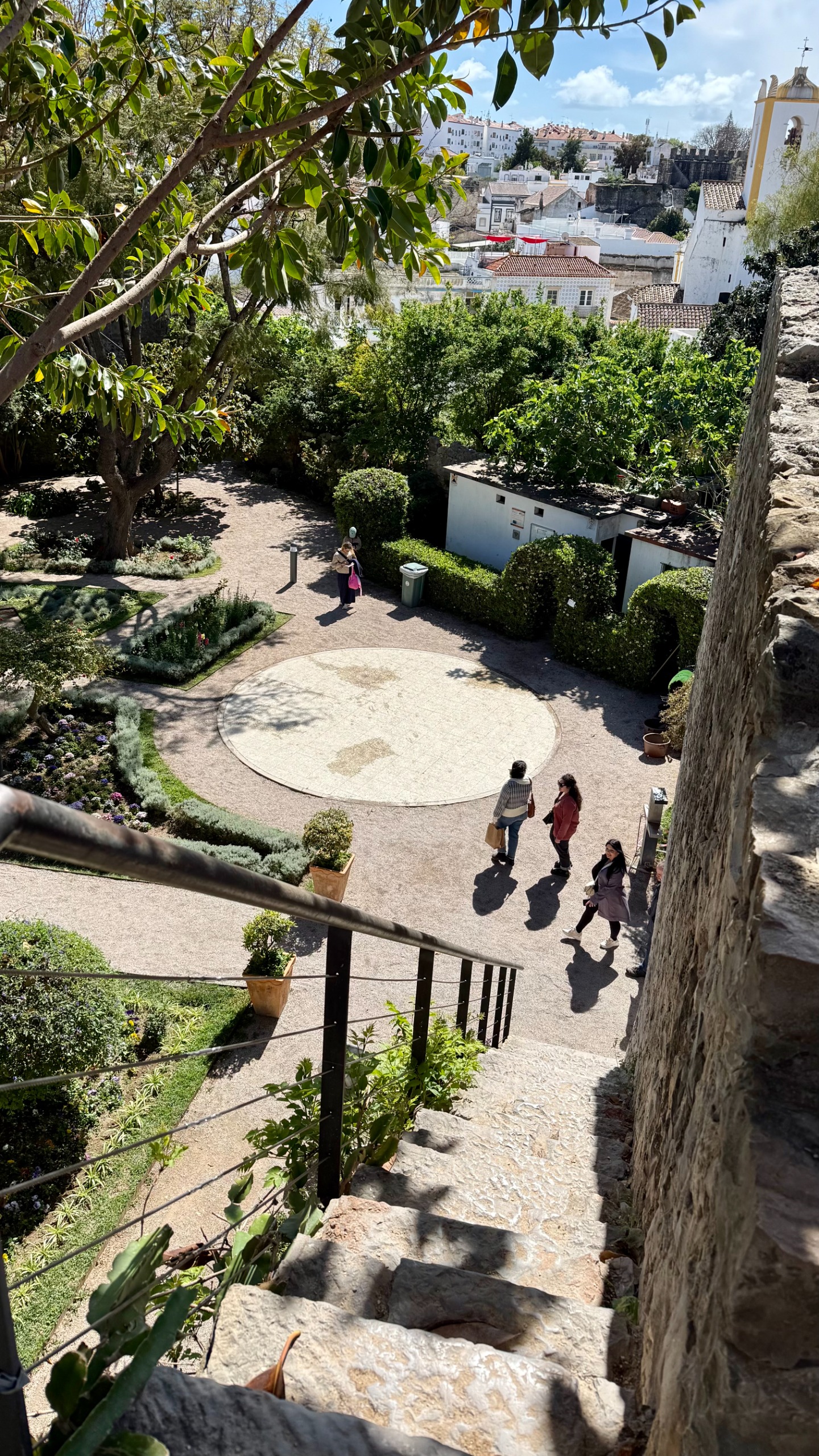 Steep steps leading down from the ruins of a castle to a garden