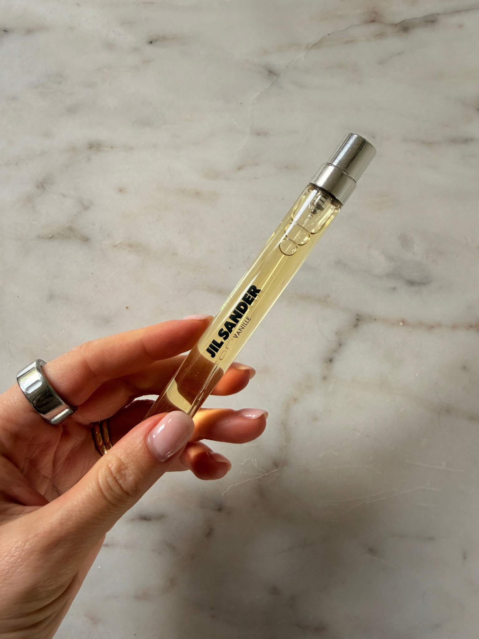 Freelance beauty editor Grace Day holding a bottle of Jil Sander Olfactory Series 1 Vanille Eau de Parfum