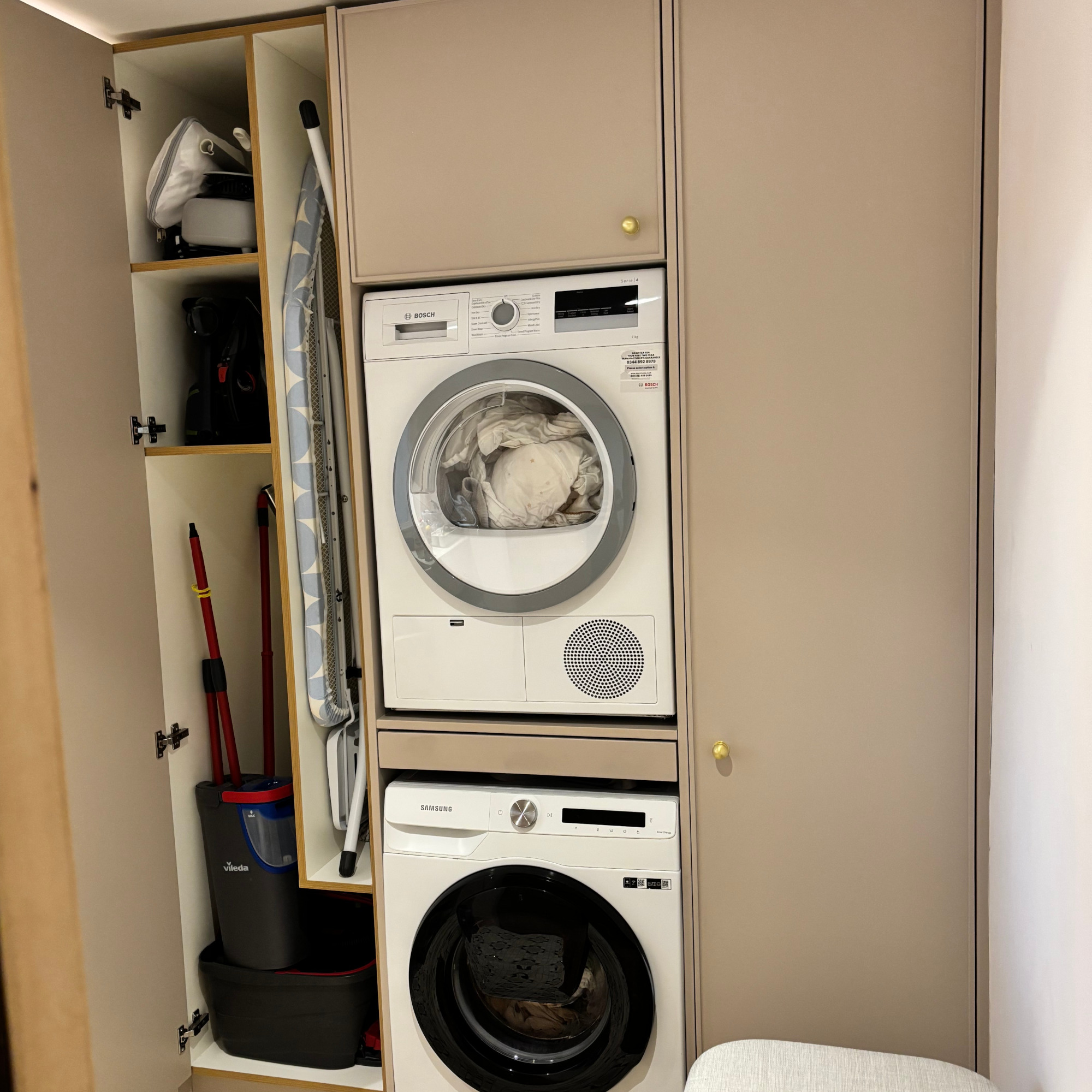 tall cupboard for ironing board etc in utility room