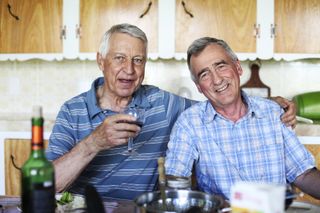 Two elderly men smiling