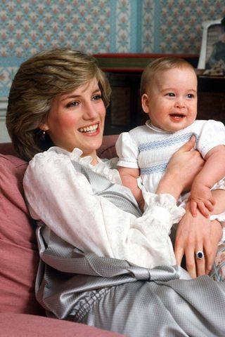 Princess Diana posing with Prince William as a baby